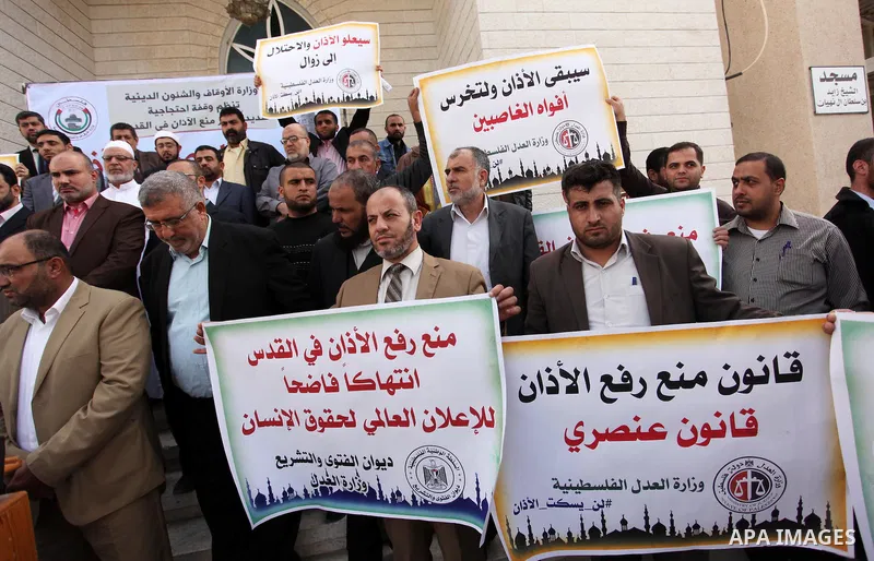 Palestinians hold banners during a protest against a controversial Israeli bill to limit the volume of calls to prayer at mosques in the occupied Jerusalem, in Gaza city on November 23, 2016. Israeli Prime Minister Benja...