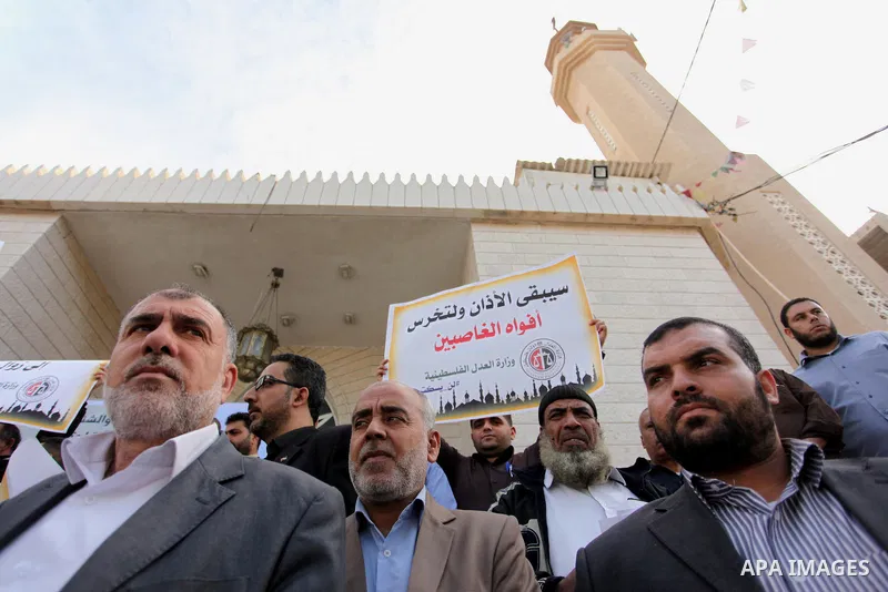 Palestinians hold banners during a protest against a controversial Israeli bill to limit the volume of calls to prayer at mosques in the occupied Jerusalem, in Gaza city on November 23, 2016. Israeli Prime Minister Benja...