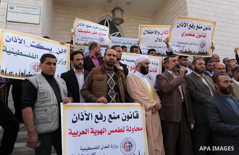 Palestinians hold banners during a protest against a controversial Israeli bill to limit the volume of calls to prayer at mosques in the occupied Jerusalem, in Gaza city on November 23, 2016. Israeli Prime Minister Benja...