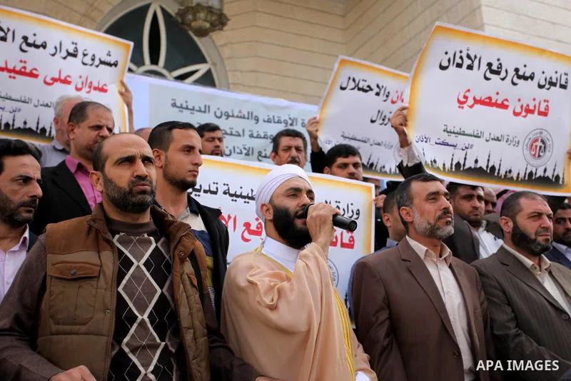 Palestinians hold banners during a protest against a controversial Israeli bill to limit the volume of calls to prayer at mosques in the occupied Jerusalem, in Gaza city on November 23, 2016. Israeli Prime Minister Benja...