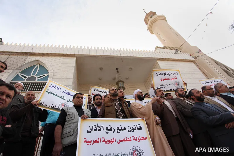 Palestinians hold banners during a protest against a controversial Israeli bill to limit the volume of calls to prayer at mosques in the occupied Jerusalem, in Gaza city on November 23, 2016. Israeli Prime Minister Benja...