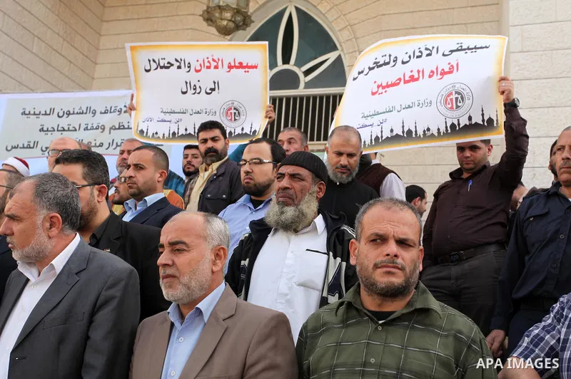 Palestinians hold banners during a protest against a controversial Israeli bill to limit the volume of calls to prayer at mosques in the occupied Jerusalem, in Gaza city on November 23, 2016. Israeli Prime Minister Benja...