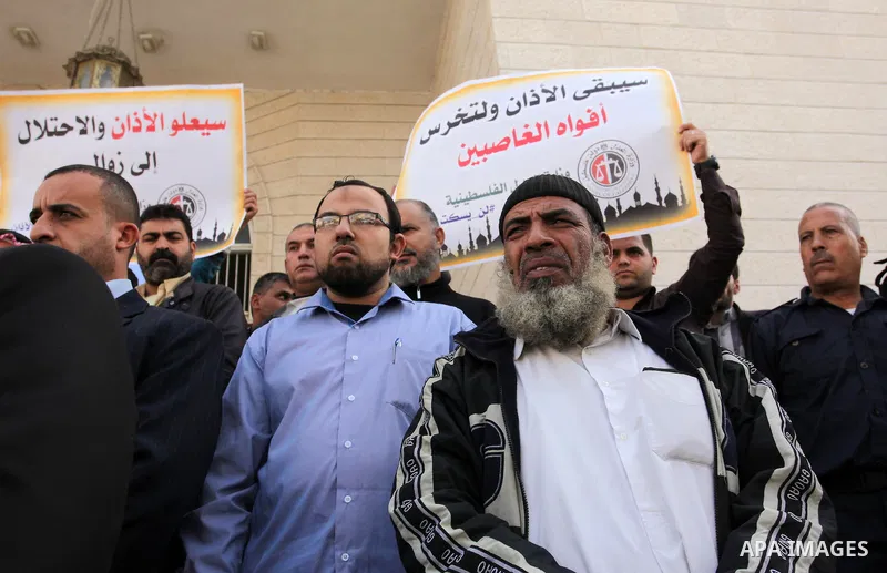 Palestinians hold banners during a protest against a controversial Israeli bill to limit the volume of calls to prayer at mosques in the occupied Jerusalem, in Gaza city on November 23, 2016. Israeli Prime Minister Benja...