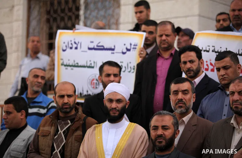Palestinians hold banners during a protest against a controversial Israeli bill to limit the volume of calls to prayer at mosques in the occupied Jerusalem, in Gaza city on November 23, 2016. Israeli Prime Minister Benja...
