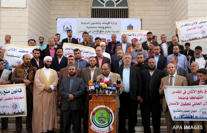 Palestinians hold banners during a protest against a controversial Israeli bill to limit the volume of calls to prayer at mosques in the occupied Jerusalem, in Gaza city on November 23, 2016. Israeli Prime Minister Benja...