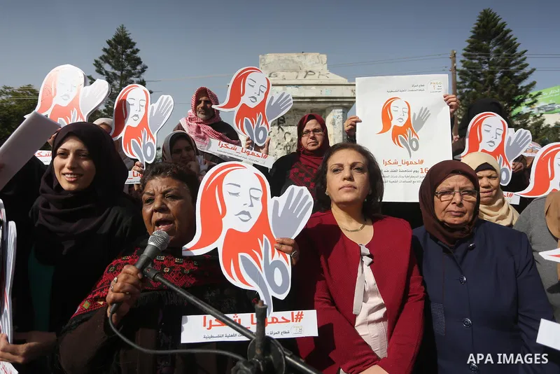Palestinian women hold banners during international campaign against violence against women, in Gaza City, on November 24, 2016. Photo by Mohammed Asad