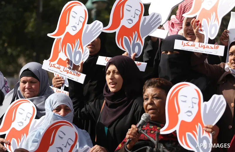 Palestinian women hold banners during international campaign against violence against women, in Gaza City, on November 24, 2016. Photo by Mohammed Asad