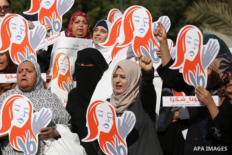 Palestinian women hold banners during international campaign against violence against women, in Gaza City, on November 24, 2016. Photo by Mohammed Asad