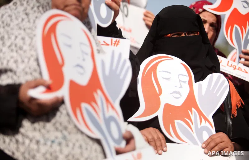 Palestinian women hold banners during international campaign against violence against women, in Gaza City, on November 24, 2016. Photo by Ashraf Amra