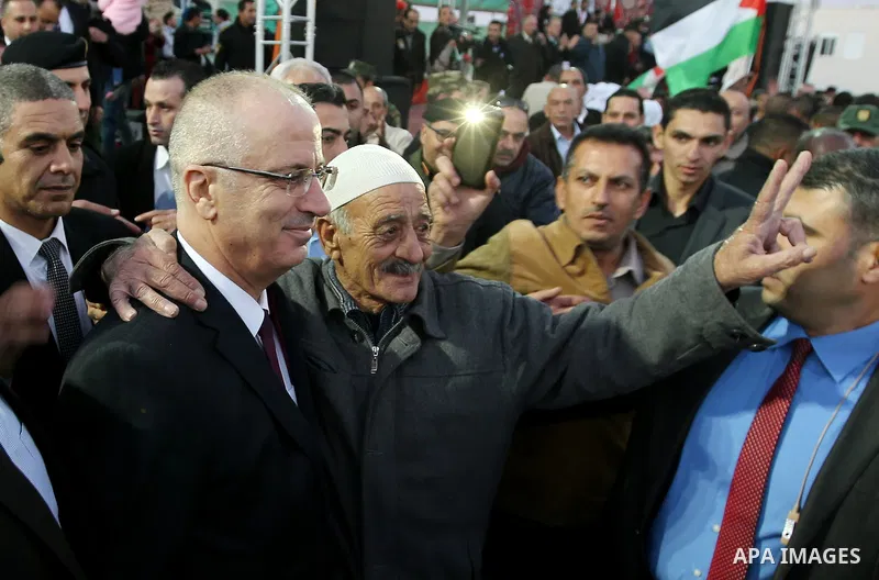 Palestinian Prime Minister Rami Hamdallah attends a mass wedding ceremony supported by Palestinian President Mahmoud Abbas, in the West Bank city of Jenin on Nov. 24, 2016. Photo by Prime Minister Office