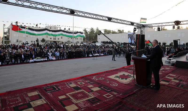 Palestinian Prime Minister Rami Hamdallah speaks during a mass wedding ceremony supported by Palestinian President Mahmoud Abbas, in the West Bank city of Jenin on Nov. 24, 2016. Photo by Prime Minister Office