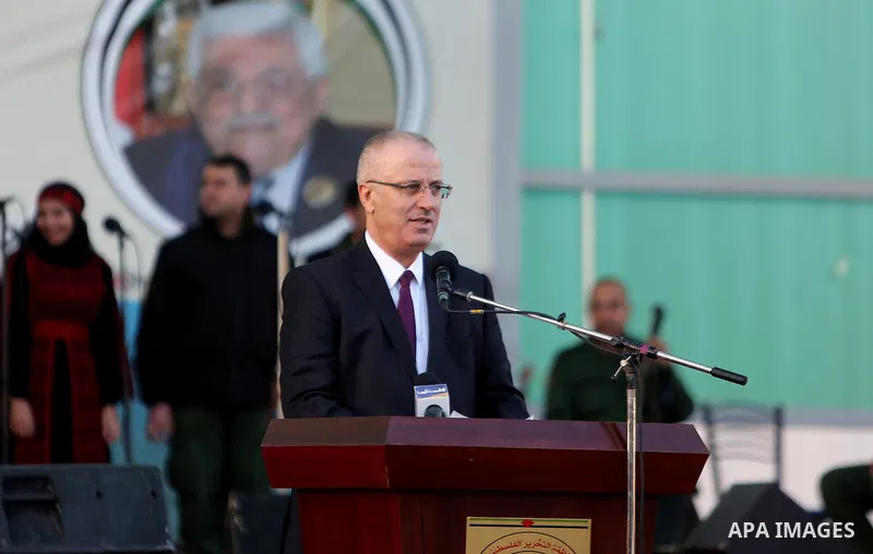 Palestinian Prime Minister Rami Hamdallah speaks during a mass wedding ceremony supported by Palestinian President Mahmoud Abbas, in the West Bank city of Jenin on Nov. 24, 2016. Photo by Prime Minister Office