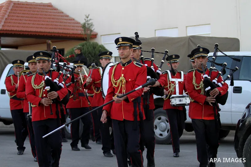 Members of a Palestinian military band sound bugles in a mass wedding ceremony for 27 couples, supported by Palestinian President Mahmoud Abbas in the West Bank city of Jenin November 24, 2016. Photo by Nedal Eshtayah