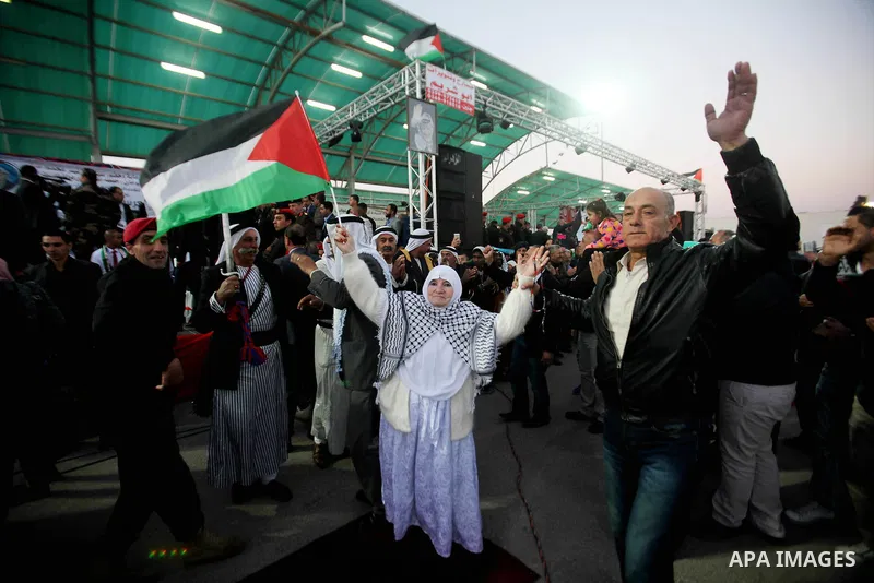 A Palestinian women dances in a mass wedding ceremony for 27 couples, supported by Palestinian President Mahmoud Abbas in the West Bank city of Jenin November 24, 2016. Photo by Nedal Eshtayah