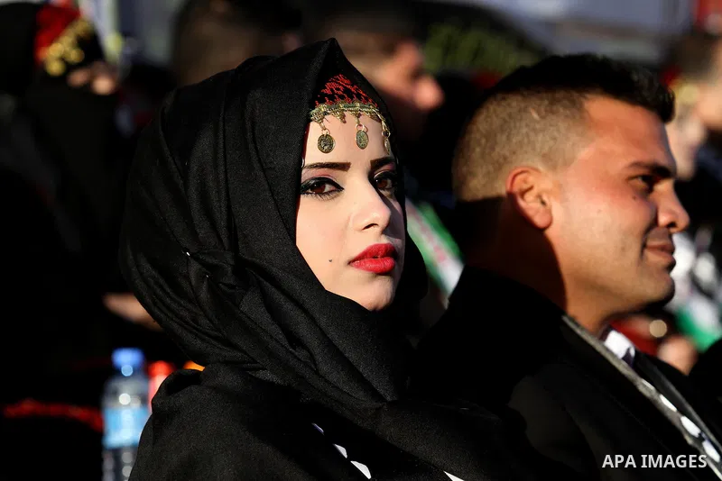 Palestinian brides and grooms take part in a mass wedding ceremony for 27 couples, supported by Palestinian President Mahmoud Abbas in the West Bank city of Jenin November 24, 2016. Photo by Nedal Eshtayah