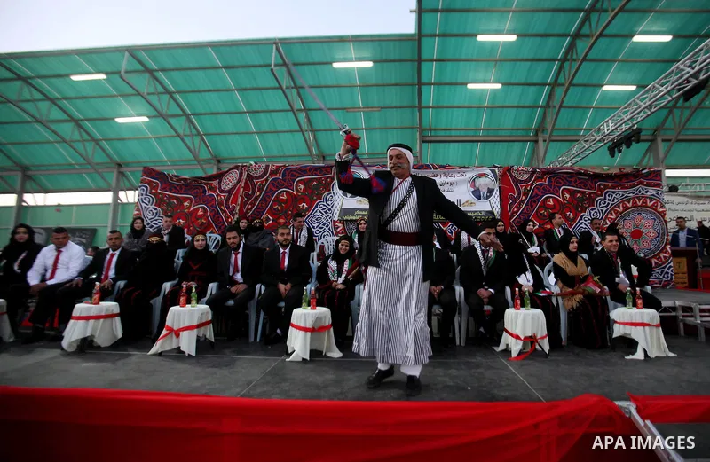 A Palestinian man dances in a mass wedding ceremony for 27 couples, supported by Palestinian President Mahmoud Abbas in the West Bank city of Jenin November 24, 2016. Photo by Nedal Eshtayah
