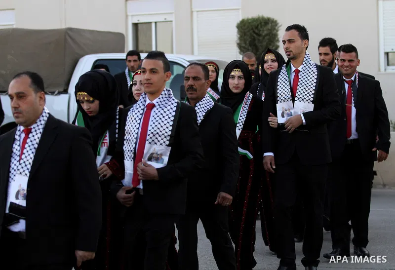 Palestinian brides and grooms take part in a mass wedding ceremony for 27 couples, supported by Palestinian President Mahmoud Abbas in the West Bank city of Jenin November 24, 2016. Photo by Nedal Eshtayah
