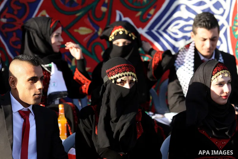 Palestinian brides and grooms take part in a mass wedding ceremony for 27 couples, supported by Palestinian President Mahmoud Abbas in the West Bank city of Jenin November 24, 2016. Photo by Nedal Eshtayah