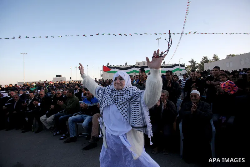 A Palestinian women dances in a mass wedding ceremony for 27 couples, supported by Palestinian President Mahmoud Abbas in the West Bank city of Jenin November 24, 2016. Photo by Nedal Eshtayah