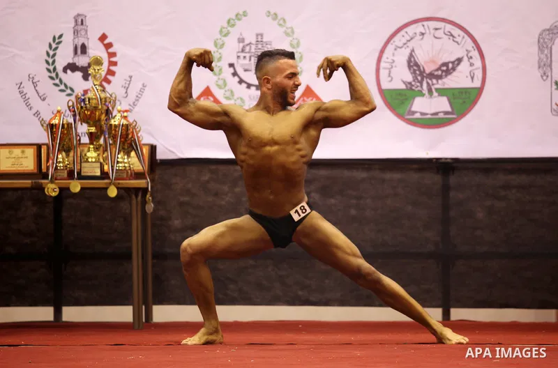 A Palestinian participant poses during a bodybuilding competition in the West Bank city of Nablus November 25, 2016. Photo by Nedal Eshtayah