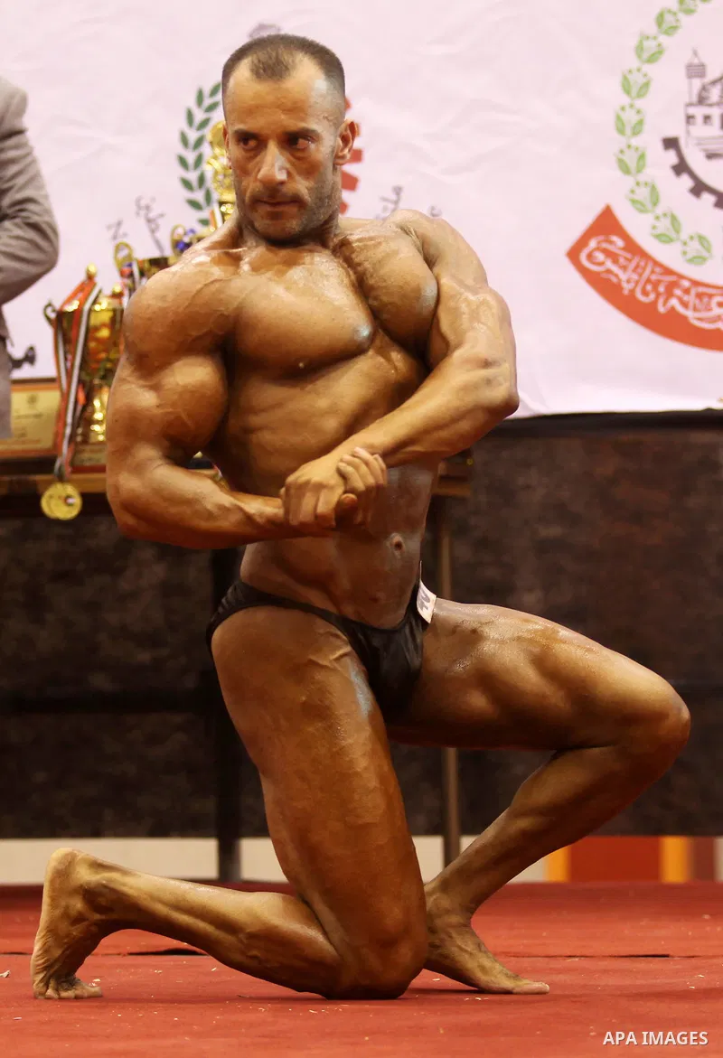 A Palestinian participant poses during a bodybuilding competition in the West Bank city of Nablus November 25, 2016. Photo by Nedal Eshtayah