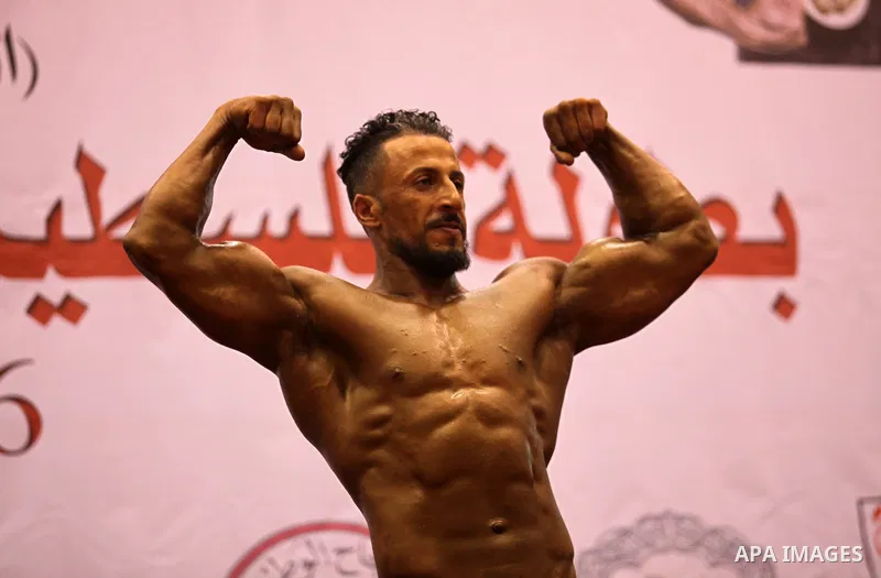 A Palestinian participant poses during a bodybuilding competition in the West Bank city of Nablus November 25, 2016. Photo by Nedal Eshtayah