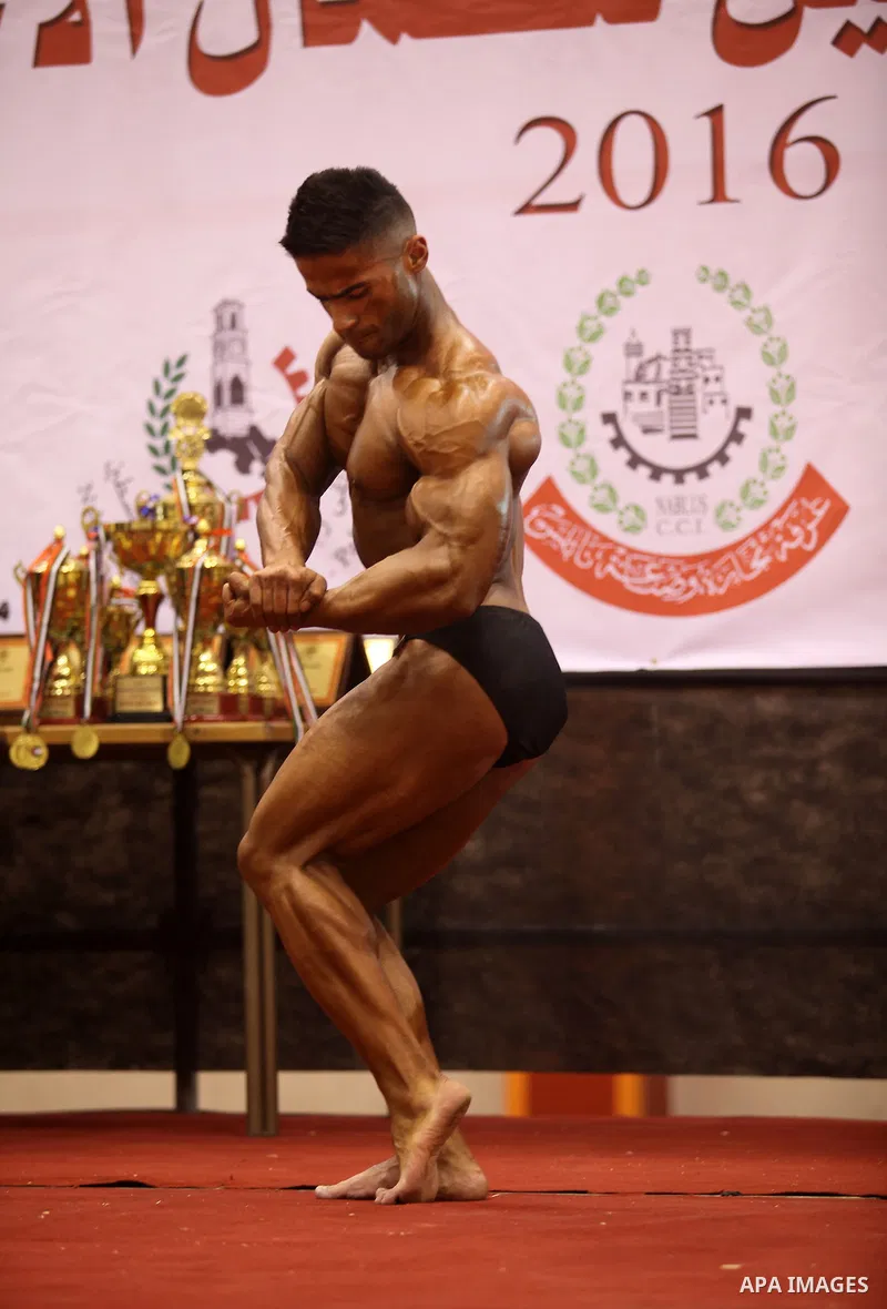 A Palestinian participant poses during a bodybuilding competition in the West Bank city of Nablus November 25, 2016. Photo by Nedal Eshtayah