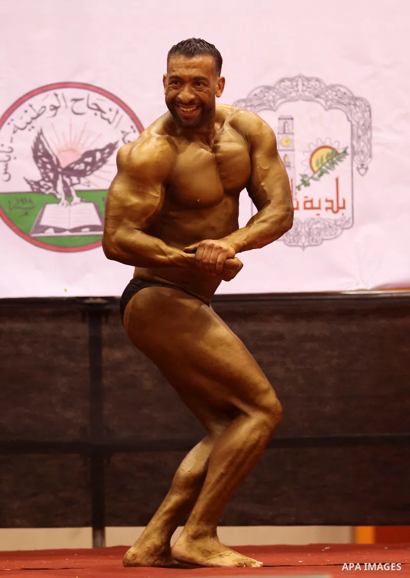 A Palestinian participant poses during a bodybuilding competition in the West Bank city of Nablus November 25, 2016. Photo by Nedal Eshtayah
