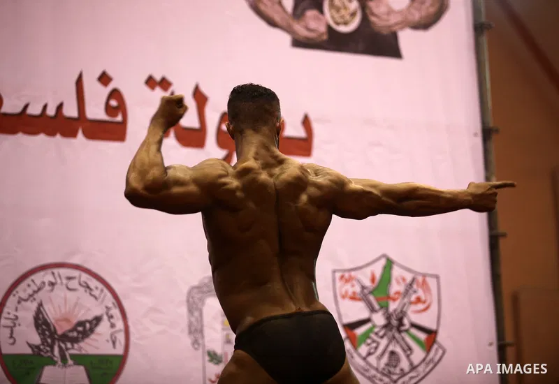 A Palestinian participant poses during a bodybuilding competition in the West Bank city of Nablus November 25, 2016. Photo by Nedal Eshtayah
