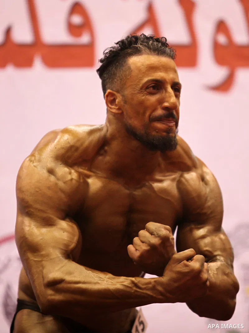 A Palestinian participant poses during a bodybuilding competition in the West Bank city of Nablus November 25, 2016. Photo by Nedal Eshtayah