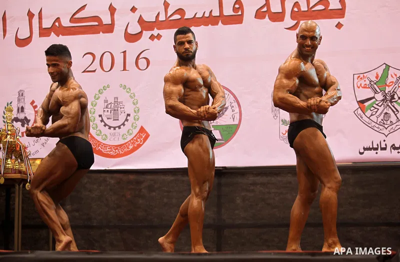 Palestinian participants pose during a bodybuilding competition in the West Bank city of Nablus November 25, 2016. Photo by Nedal Eshtayah