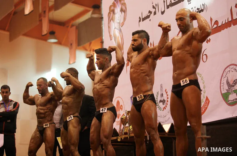 Palestinian participants pose during a bodybuilding competition in the West Bank city of Nablus November 25, 2016. Photo by Nedal Eshtayah