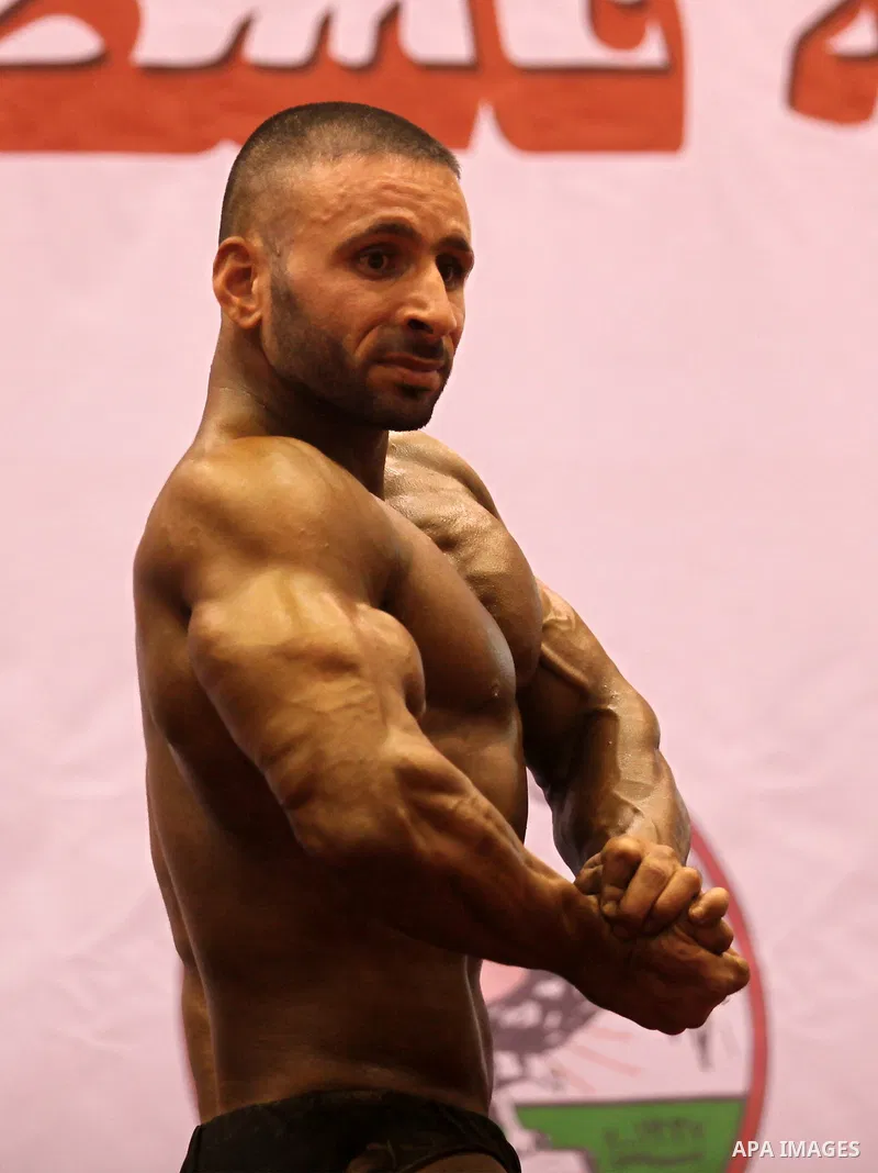 A Palestinian participant poses during a bodybuilding competition in the West Bank city of Nablus November 25, 2016. Photo by Nedal Eshtayah