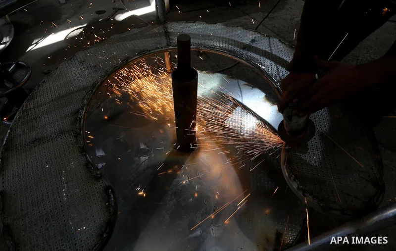 Palestinian men work on the manufacture and maintenance of the swings "amusement games" at al-salam factory in the Zeitoun neighborhood, in Gaza city, on November 26, 2016. Israeli occupation prevented of the introductio...