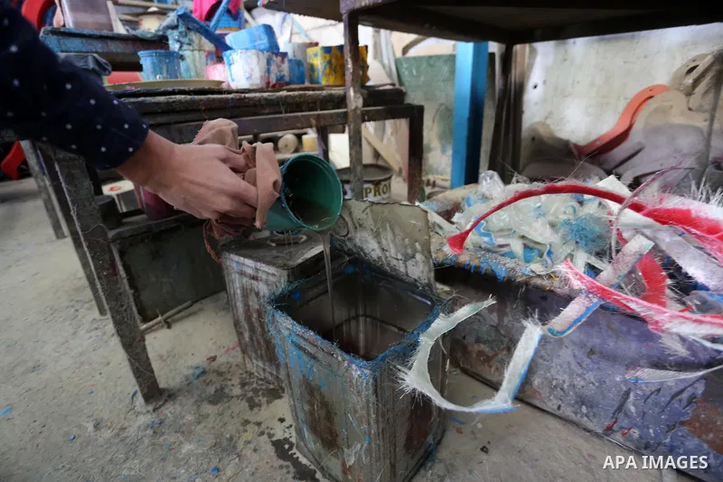 Palestinian men work on the manufacture and maintenance of the swings "amusement games" at al-salam factory in the Zeitoun neighborhood, in Gaza city, on November 26, 2016. Israeli occupation prevented of the introductio...