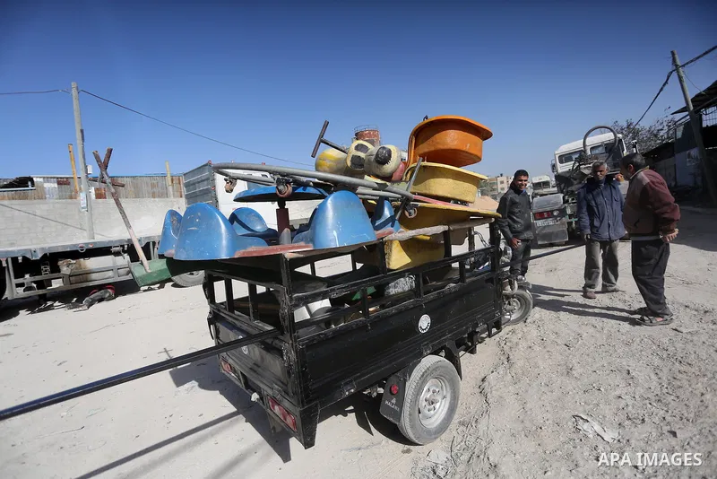 Palestinian men work on the manufacture and maintenance of the swings "amusement games" at al-salam factory in the Zeitoun neighborhood, in Gaza city, on November 26, 2016. Israeli occupation prevented of the introductio...