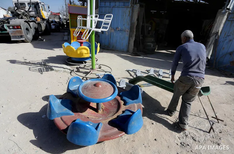 Palestinian men work on the manufacture and maintenance of the swings "amusement games" at al-salam factory in the Zeitoun neighborhood, in Gaza city, on November 26, 2016. Israeli occupation prevented of the introductio...