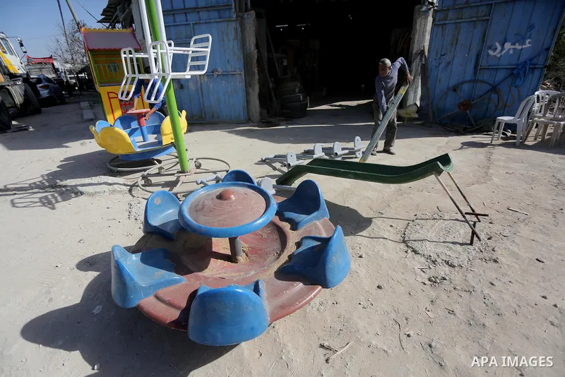 Palestinian men work on the manufacture and maintenance of the swings "amusement games" at al-salam factory in the Zeitoun neighborhood, in Gaza city, on November 26, 2016. Israeli occupation prevented of the introductio...