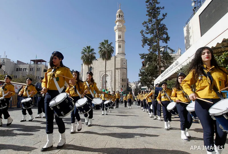 Palestinian scouts march as Custodian of the Holy Land Father Francesco Patton arrives to the Church of the Nativity to ceremonially launch the beginning of the Christmas season, in the West Bank city of Bethlehem Novemb...