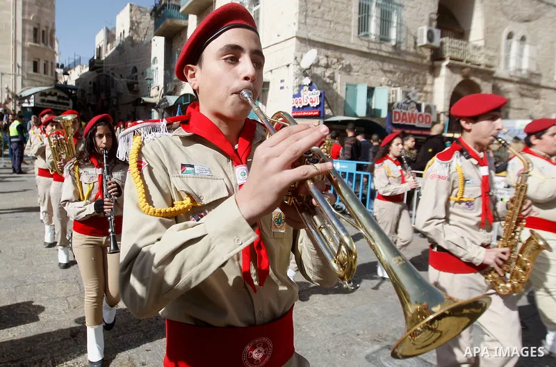 Palestinian scouts march as Custodian of the Holy Land Father Francesco Patton arrives to the Church of the Nativity to ceremonially launch the beginning of the Christmas season, in the West Bank city of Bethlehem Novemb...