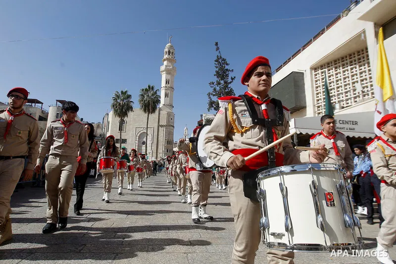 Palestinian scouts march as Custodian of the Holy Land Father Francesco Patton arrives to the Church of the Nativity to ceremonially launch the beginning of the Christmas season, in the West Bank city of Bethlehem Novemb...