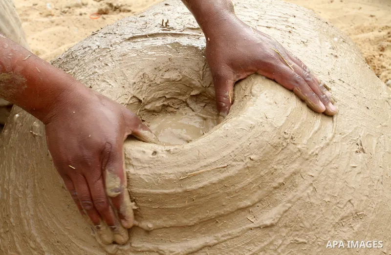 A Palestinian man, Iyad Abu Samhadana, prepares the clay ovens to earn their living, in Rafah in the southern Gaza Strip, on November 27, 2016. Photo by Abed Rahim Khatib