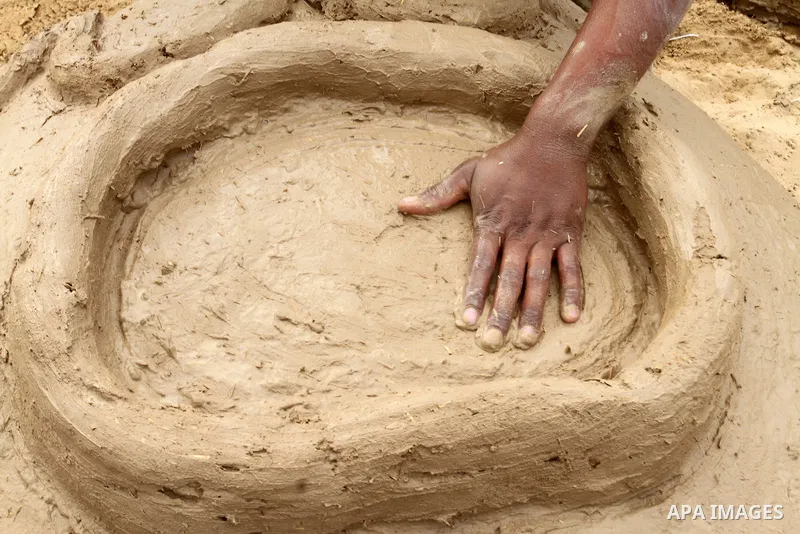 A Palestinian man, Iyad Abu Samhadana, prepares the clay ovens to earn their living, in Rafah in the southern Gaza Strip, on November 27, 2016. Photo by Abed Rahim Khatib