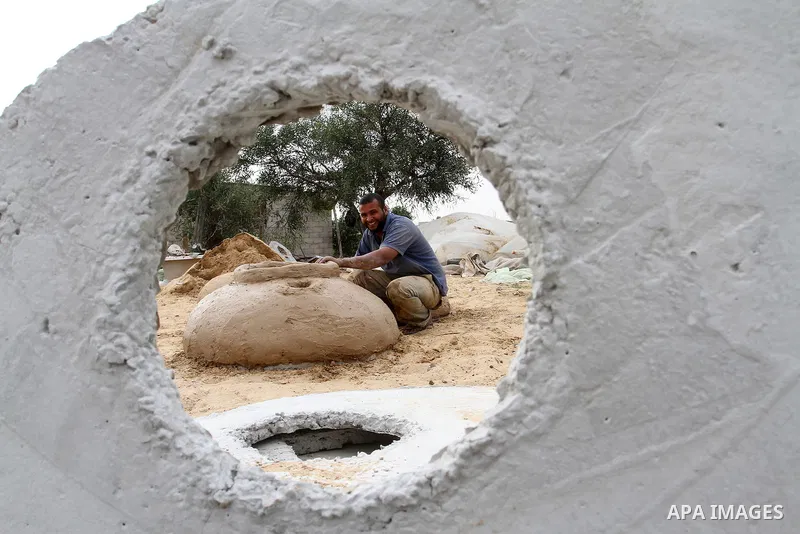 A Palestinian man, Iyad Abu Samhadana, prepares the clay ovens to earn their living, in Rafah in the southern Gaza Strip, on November 27, 2016. Photo by Abed Rahim Khatib