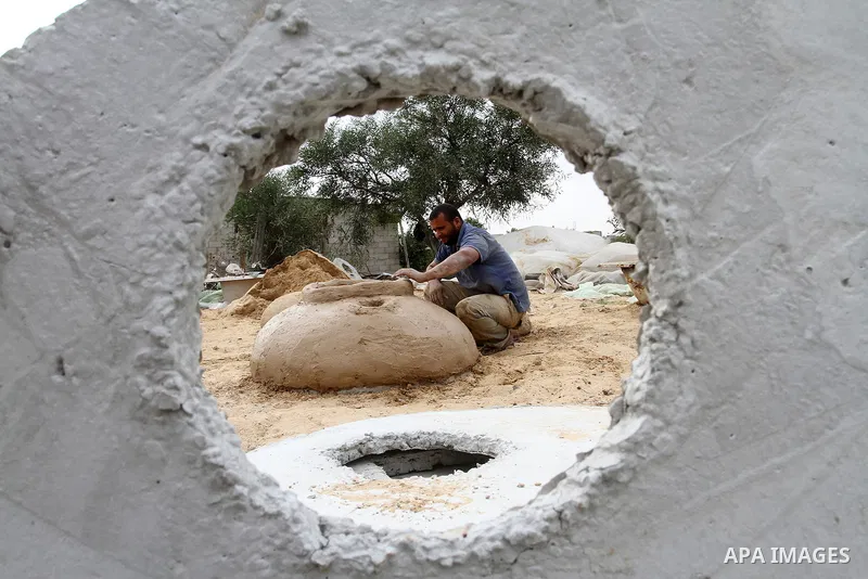 A Palestinian man, Iyad Abu Samhadana, prepares the clay ovens to earn their living, in Rafah in the southern Gaza Strip, on November 27, 2016. Photo by Abed Rahim Khatib