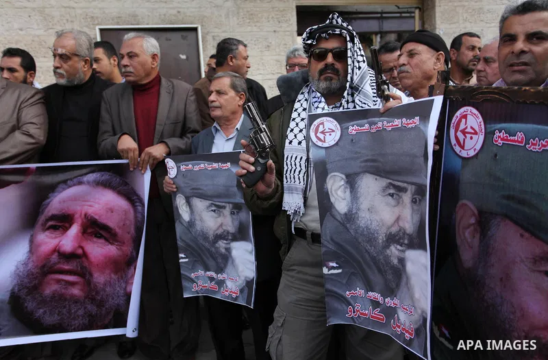 Palestinian men hold posters of late Cuban leader Fidel Castro during a gathering in Gaza city on November 28, 2016 to pay tribute him after his death. Cuban revolutionary icon Fidel Castro died late November 25 in Havan...