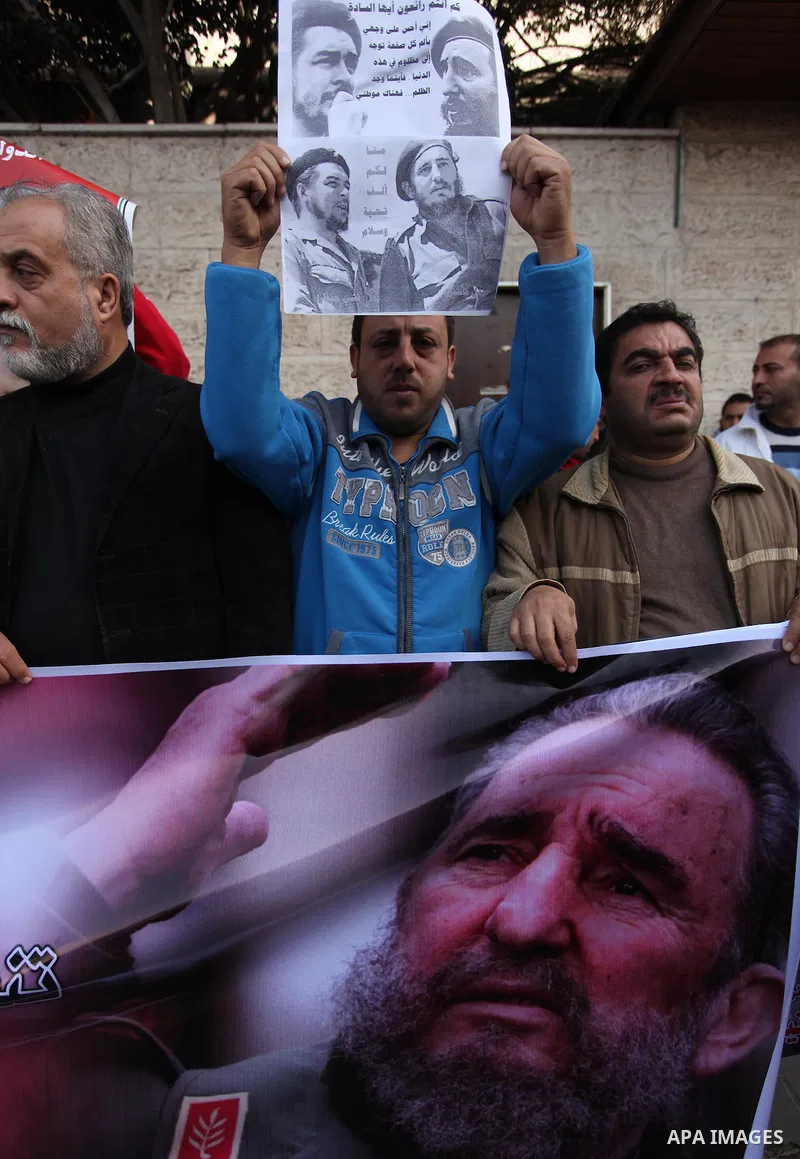 Palestinian men hold posters of late Cuban leader Fidel Castro during a gathering in Gaza city on November 28, 2016 to pay tribute him after his death. Cuban revolutionary icon Fidel Castro died late November 25 in Havan...