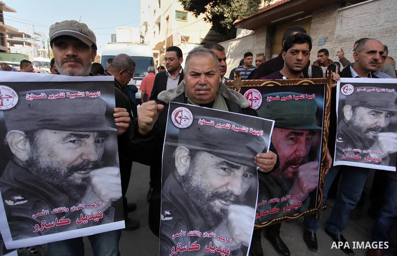 Palestinian men hold posters of late Cuban leader Fidel Castro during a gathering in Gaza city on November 28, 2016 to pay tribute him after his death. Cuban revolutionary icon Fidel Castro died late November 25 in Havan...