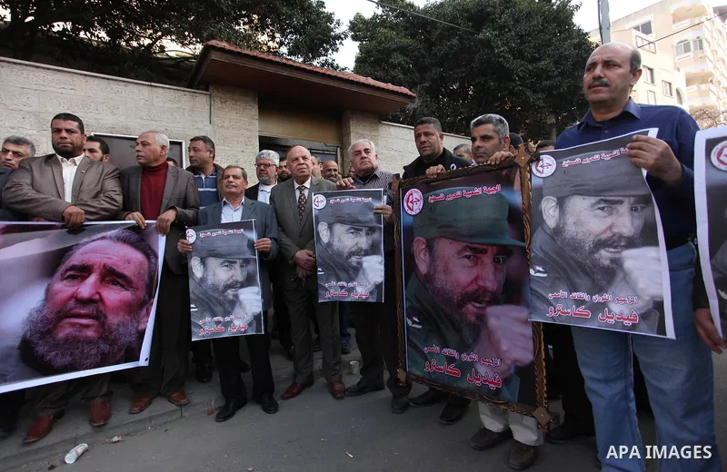 Palestinian men hold posters of late Cuban leader Fidel Castro during a gathering in Gaza city on November 28, 2016 to pay tribute him after his death. Cuban revolutionary icon Fidel Castro died late November 25 in Havan...