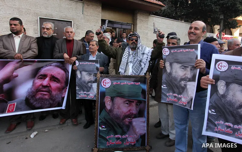 Palestinian men hold posters of late Cuban leader Fidel Castro during a gathering in Gaza city on November 28, 2016 to pay tribute him after his death. Cuban revolutionary icon Fidel Castro died late November 25 in Havan...